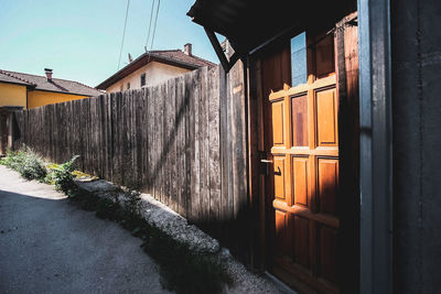 Exterior of house by building against sky