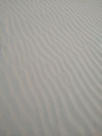 High angle view of tire tracks on sand