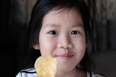 Portrait of girl having potato chip