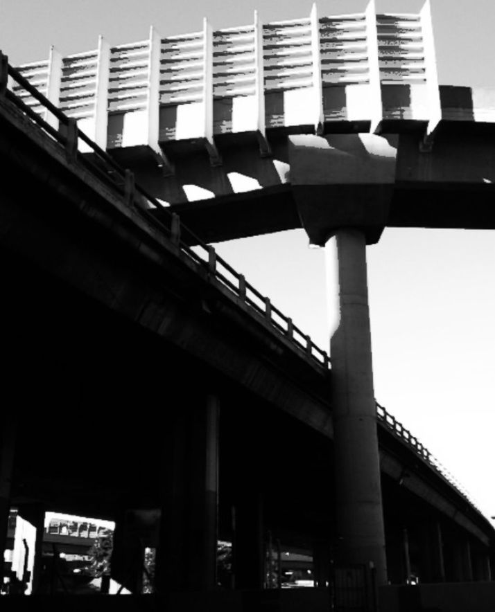 architecture, built structure, low angle view, building exterior, city, connection, clear sky, bridge - man made structure, modern, building, engineering, architectural column, sky, outdoors, no people, day, transportation, street light, city life, bridge