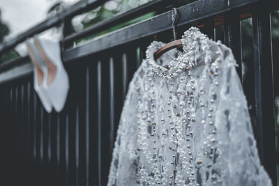 Close-up of clothes hanging on window at store