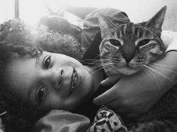 Close-up portrait of boy with cat