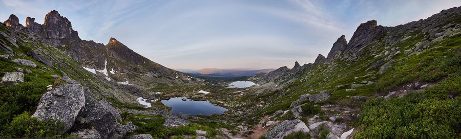 Panoramic view of rocks and mountains against sky