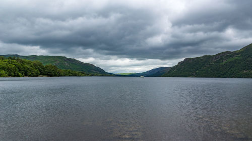 Scenic view of mountains against cloudy sky