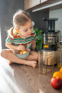 Portrait of cute baby boy sitting on table