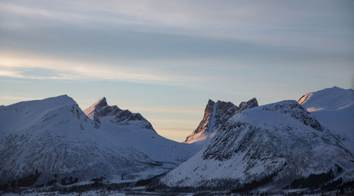 Scenic view of snowcapped mountains against sky during sunset