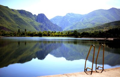 Scenic view of lake and mountains against sky