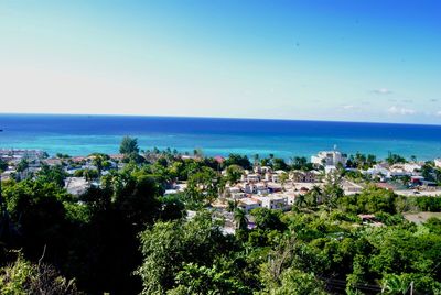 High angle view of townscape by sea against sky