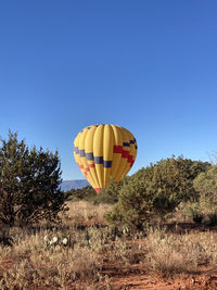 Low angle view of kite against clear blue sky