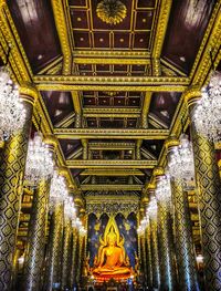 Low angle view of illuminated statue in temple