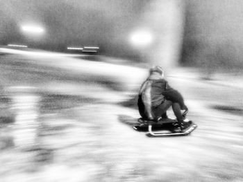 Man riding motorcycle on illuminated at night