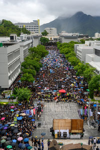 High angle view of people on street amidst buildings in city