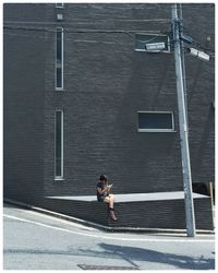 Woman using phone roadside