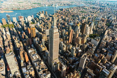 Aerial view of empire state building amidst towers at manhattan