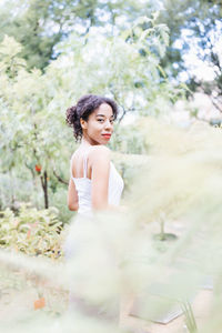 Young african american multiracial woman in park. spring or summer season