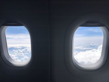 Scenic view of cloudscape seen through airplane window