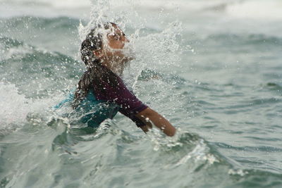 Woman jumping in sea