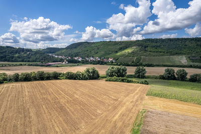 Scenic view of agricultural field against sky