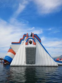 Boat sailing in sea against blue sky