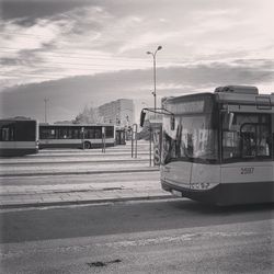 Train on street in city against sky