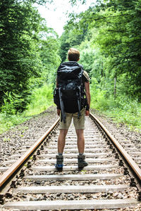 Rear view of man on railroad track