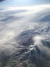 Aerial view of snowcapped mountains against sky