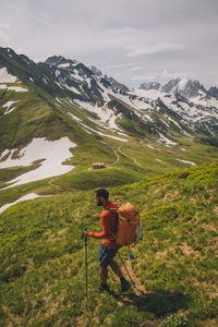 Man with umbrella on snowcapped mountain