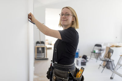 Female electrician renovating house