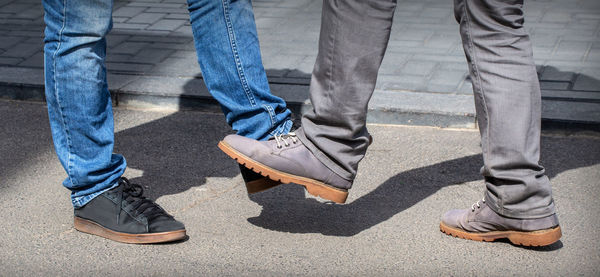 Low section of man standing on street