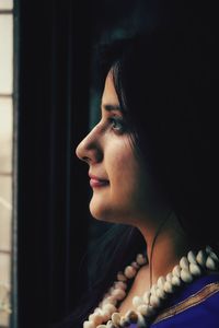 Close-up portrait of a young woman looking away