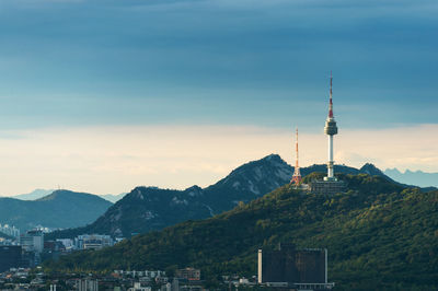 Communications tower on mountain against sky