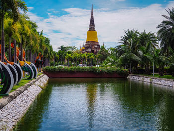 Panoramic view of trees and building against sky