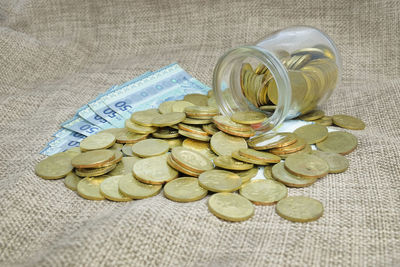 High angle view of coins on glass