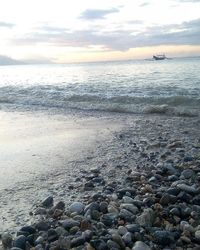 Scenic view of sea against cloudy sky