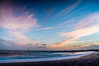 Scenic view of beach against sky during sunset