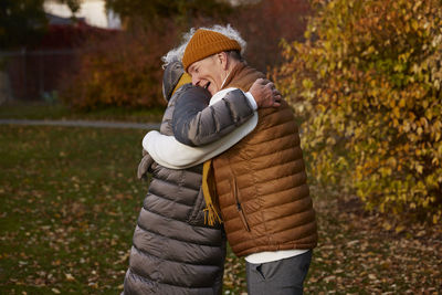 Senior couple embracing in autumn scenery