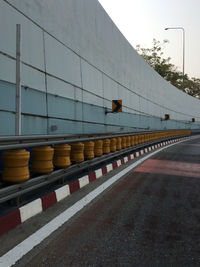 Road by building against sky