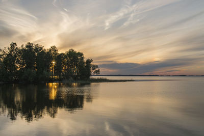 Scenic view of lake against sky at sunset