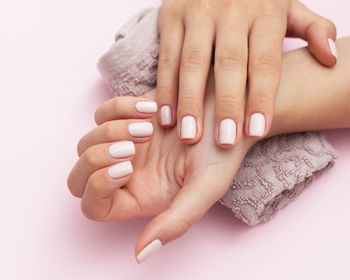 Close-up of woman hands over white background