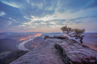 Scenic view of land against sky during sunset