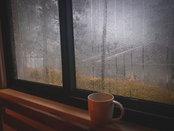 Close-up of coffee cup on window