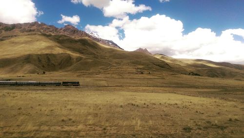 Scenic view of mountains against cloudy sky