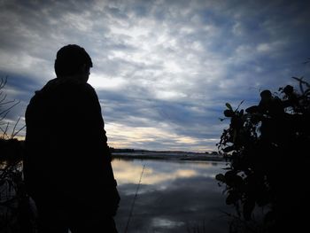 Scenic view of lake against cloudy sky