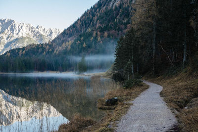 Scenic view of lake by mountain against sky