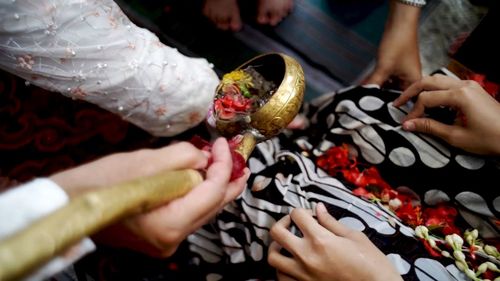 High angle view of people hand performing traditional rituals