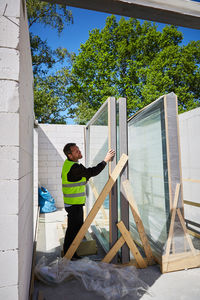 Side view of male architect working at construction site on sunny day