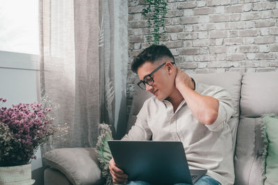 Young man using laptop at home