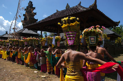 Group of people outside temple against building