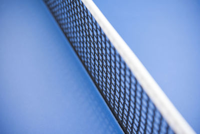 Close-up low angle view of table against clear blue sky