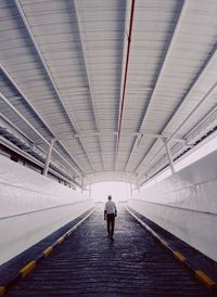 A man walking out of the tunnel